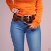 craiyon_134637_Stunningly_beautiful_woman_with_brown_hair__orange_sweater__blue_jeans__brown_belt__H.png