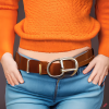 craiyon_134641_Stunningly_beautiful_woman_with_brown_hair__orange_sweater__blue_jeans__brown_belt__H.png