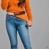 craiyon_134643_Stunningly_beautiful_woman_with_brown_hair__orange_sweater__blue_jeans__brown_belt__H.png