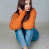 craiyon_135207_Full_body_shot_of_a_stunningly_beautiful_woman_sitting_on_the_floor__Brown_hair__oran.png