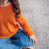 craiyon_135210_Full_body_shot_of_a_stunningly_beautiful_woman_sitting_on_the_floor__Brown_hair__oran.png