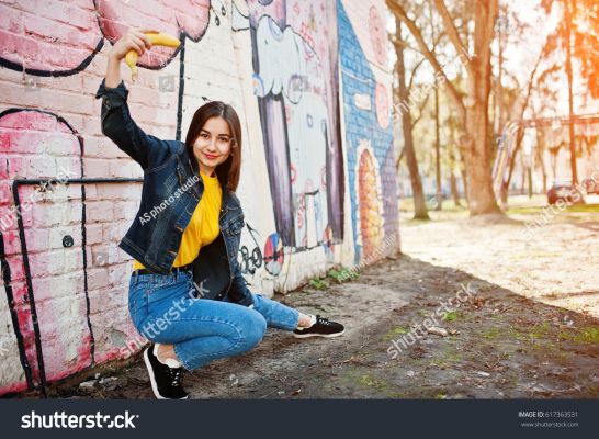 stock-photo-beautiful-fun-teenage-girl-with-banana-at-hand-wear-yellow-t-shirt-jeans-near-graffiti-wall-617363531.jpg