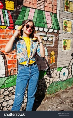 stock-photo-beautiful-fun-teenage-girl-with-bananas-at-hands-wear-yellow-t-shirt-jeans-and-sunglasses-near-617116541.jpg