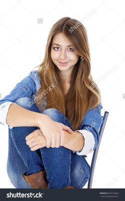 stock-photo-portrait-young-girl-in-a-jacket-and-blue-jeans-sitting-on-a-chair-isolated-on-white-267019832.jpg