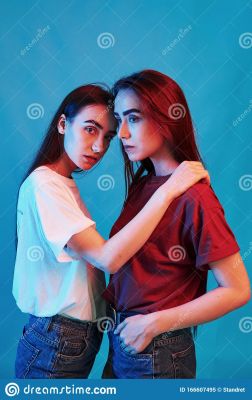 two-brunettes-studio-shot-indoors-neon-light-photo-beautiful-twins-166607495.jpg
