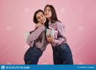 celebrating-together-young-women-having-fun-studio-pink-background-adorable-twins-celebrating-together-young-women-165456201.jpg