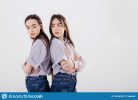 conception-two-offended-family-members-sisters-twins-standing-posing-studio-white-background-165767627.jpg