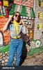 stock-photo-beautiful-fun-teenage-girl-with-bananas-at-hands-wear-yellow-t-shirt-jeans-and-sunglasses-near-617116541.jpg