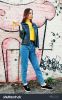 stock-photo-beautiful-teenage-girl-eat-banana-wear-yellow-t-shirt-jeans-near-graffiti-wall-617363480.jpg