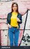 stock-photo-beautiful-teenage-girl-wear-yellow-t-shirt-and-jeans-near-graffiti-wall-617115338.jpg